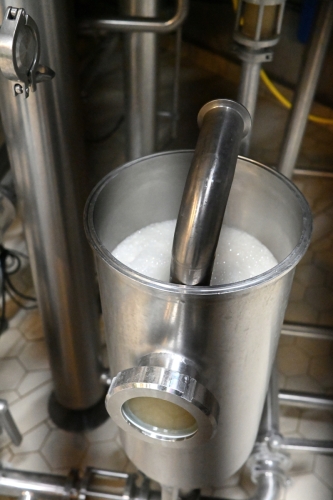 Dan's already got the first batch of the day going from the mash tank to the kettle.