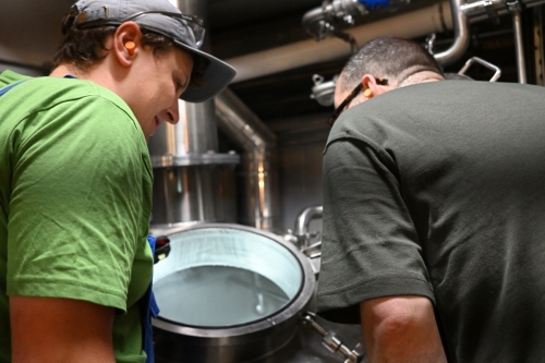 Dan shows Huw what's going the kettle, where the first batch will be transferred soon.
